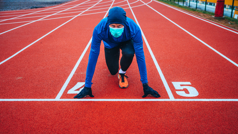 Sprinter wearing medical mask