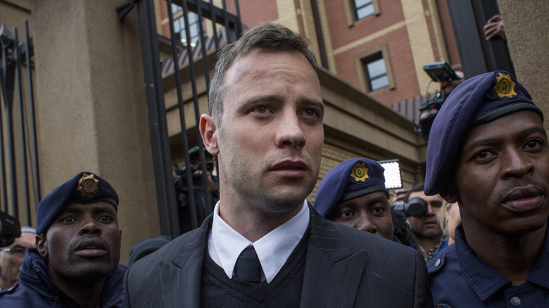 Oscar Pistorius surrounded by security