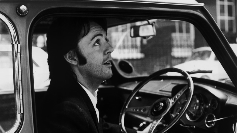Paul McCartney sitting in car