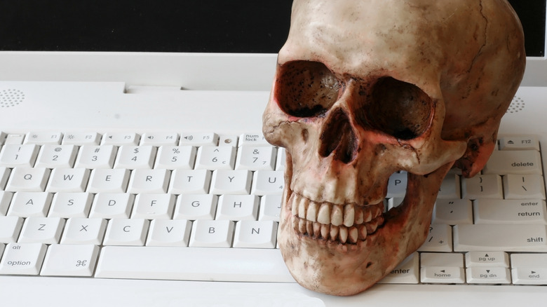 Human skull on a computer keyboard