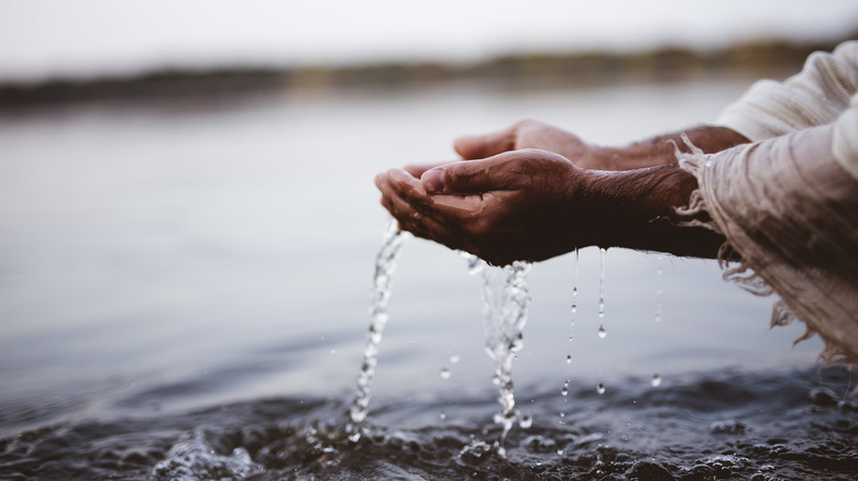 man's hands in water