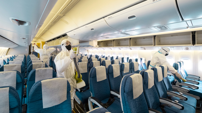 People sanitizing a plane cabin