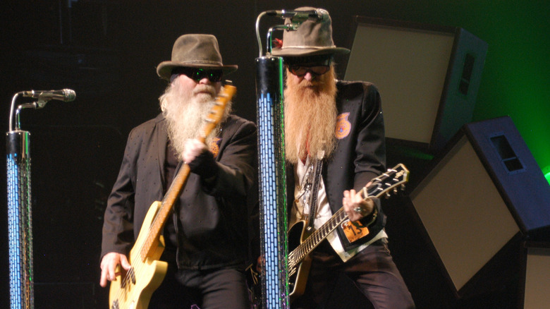 Billy Gibbons and Dusty Hill of ZZ Top play their instruments on stage.