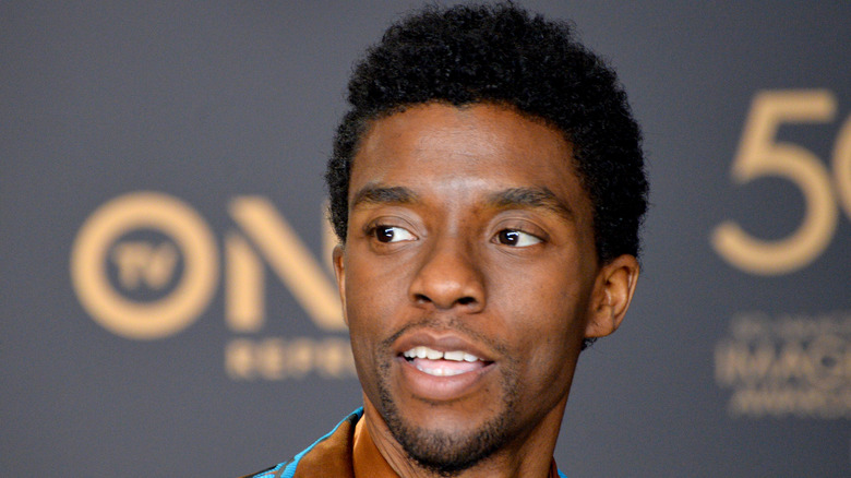 Chadwick Boseman glancing