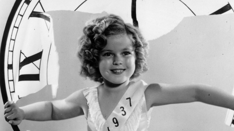 Shirley Temple in the middle of a giant clock