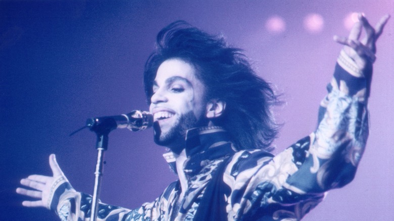 Prince smiling with arms outstretched