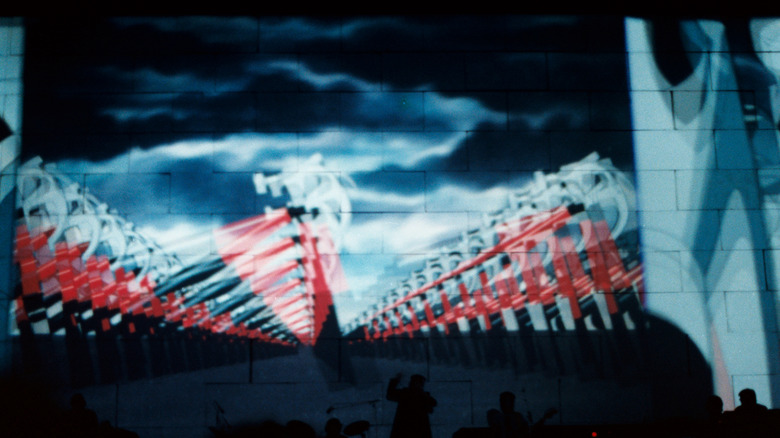 Pink Floyd performing with The Wall imagery projected behind