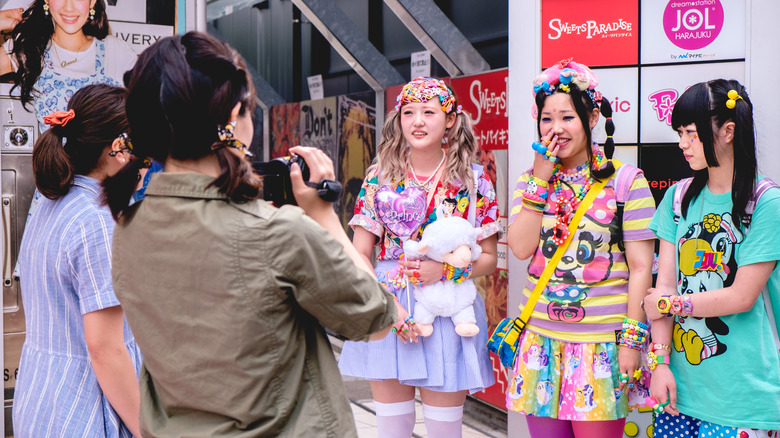 people in normcore clothes taking a photo of Harajuku girls