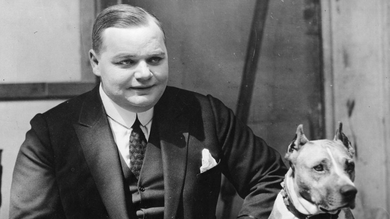 Fatty Arbuckle posing with a dog