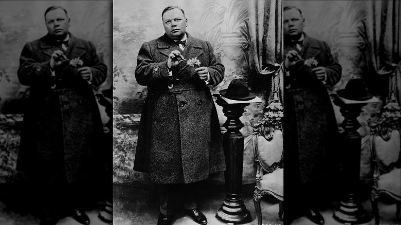 Fatty Arbuckle posing with flowers