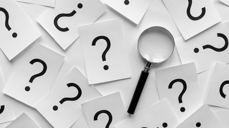 question marks with magnifying glass
