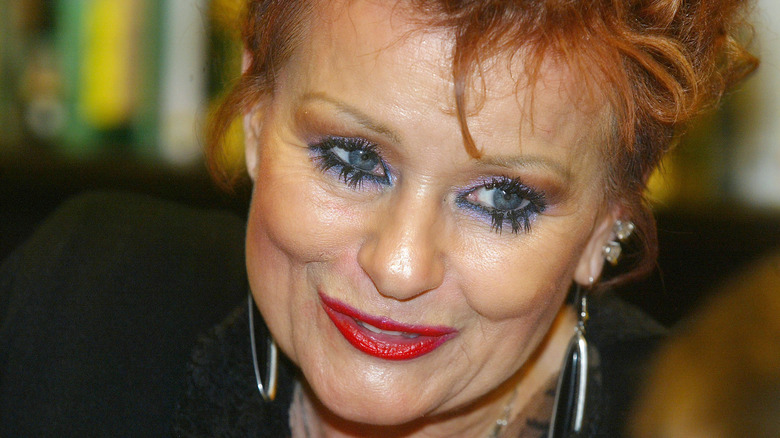 Tammy Faye Messner poses at a book signing party