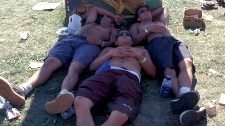Attendees resting in shade at Woodstock 99