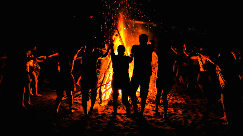 People dancing around a bonfire