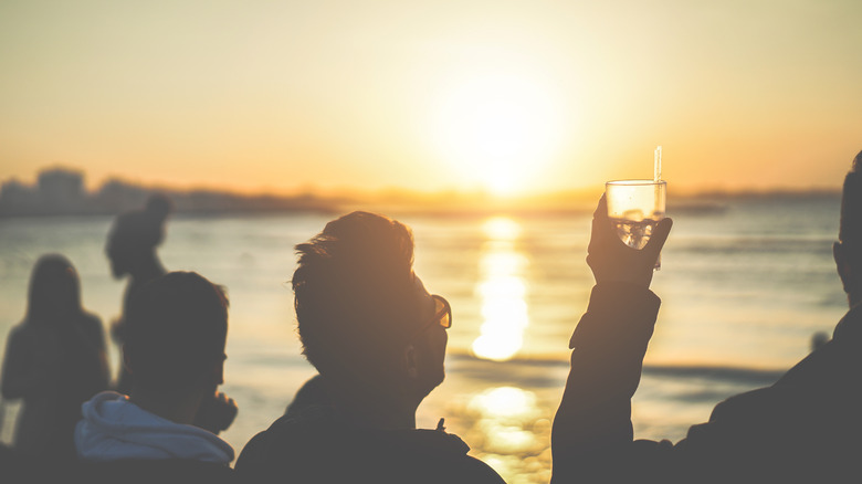 people drinking cocktails on beach