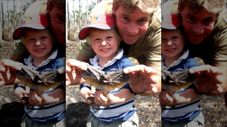 Steve and Robert Irwin holding lizard