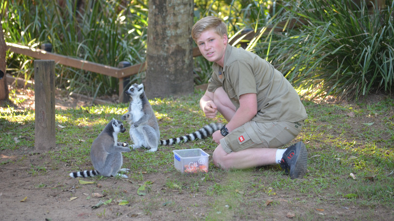 Robert Irwin posing with lemurs 