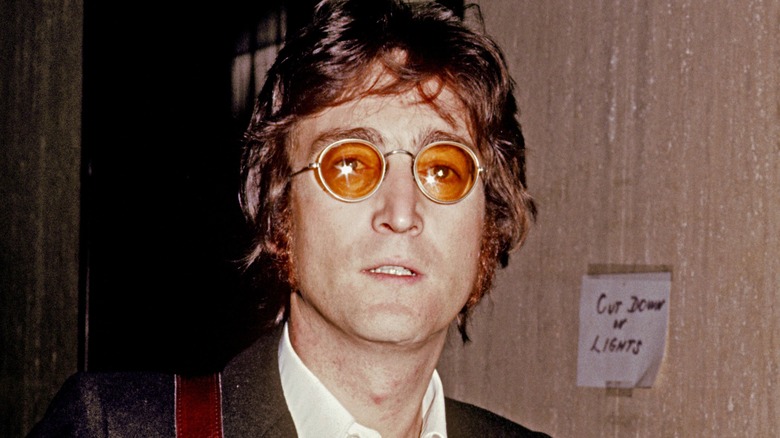 John Lennon posing for photo