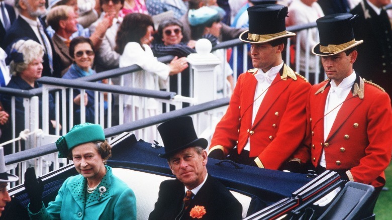 The Queen in a carriage with husband and servants 