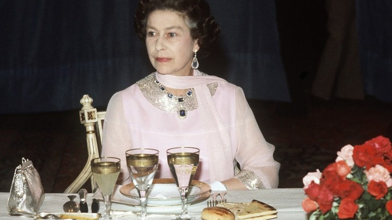 A younger Queen Elizabeth at dinner