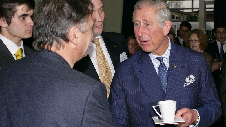 Prince Charles holding a cup of tea