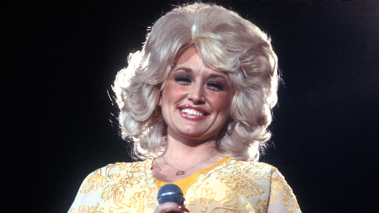 Dolly Parton smiling with mic