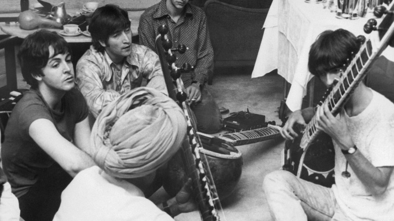 The Beatles playing sitar in India in 1968