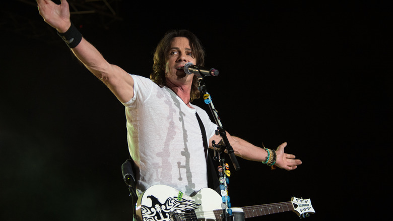 Rick Springfield singing into  microphone