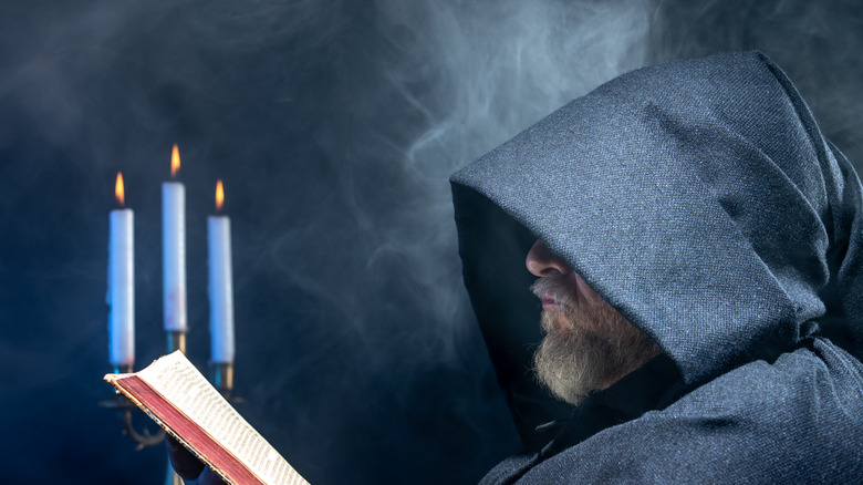 Creepy monk reading the bible