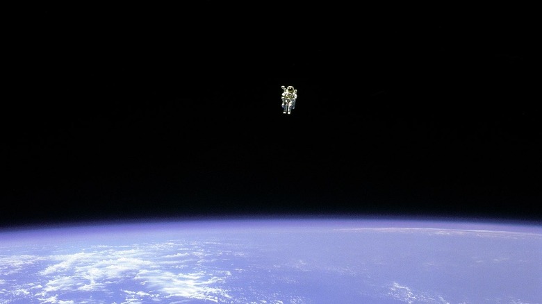 Astronaut alone in space above Earth