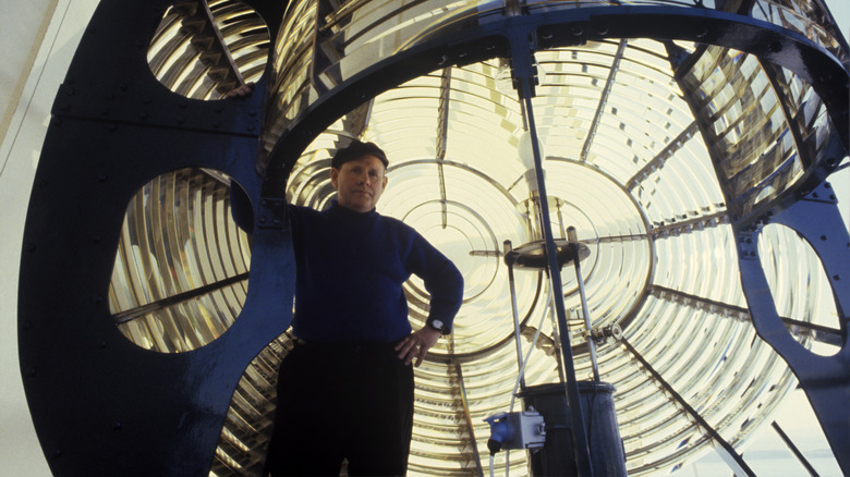 Lighthouse keeper in front of light