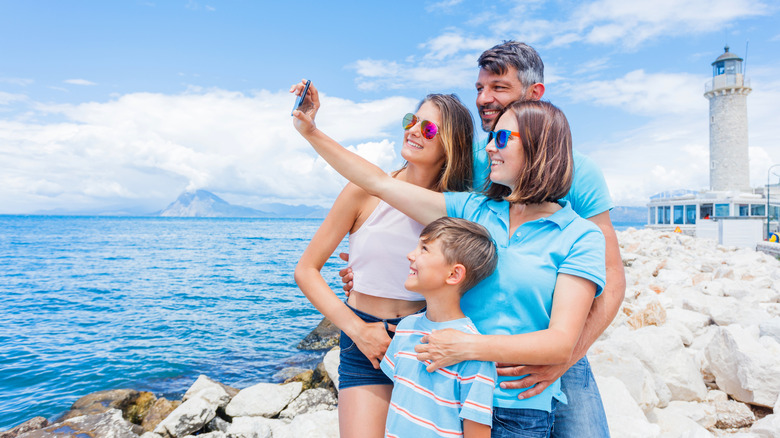 Family taking selfie with lighthouse