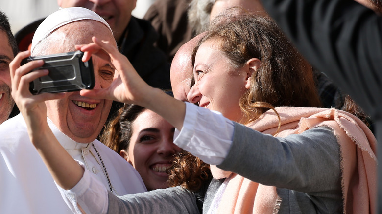 Woman taking a selfie with Pope Francis