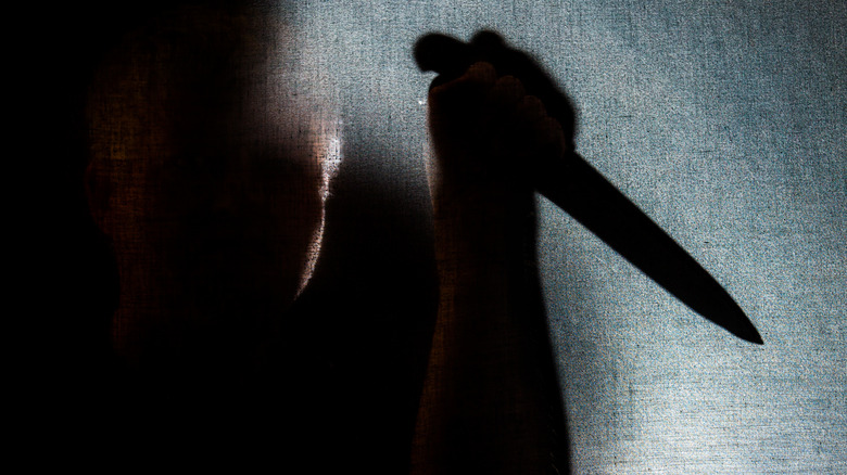 Shadowy figure holding knife