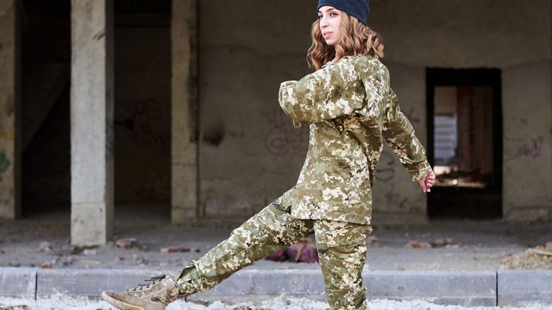 Woman marching in Ukrainian military uniform