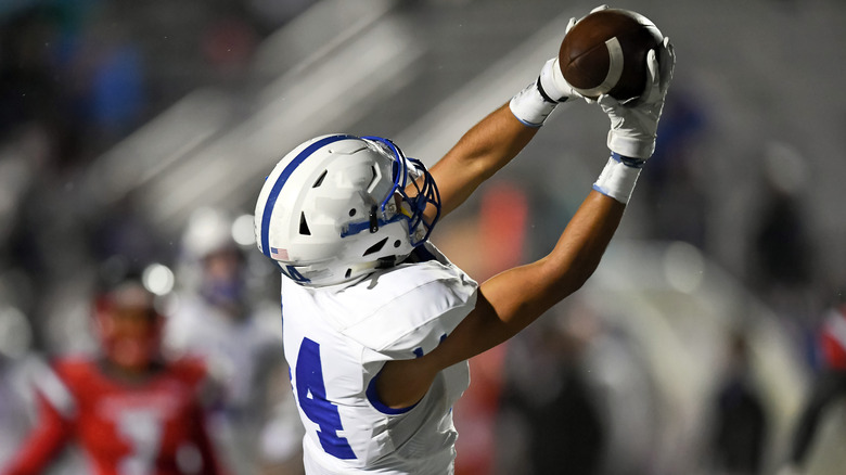 High school football player catches a pass