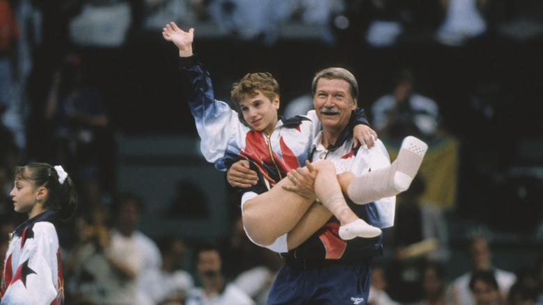 Béla Károlyi carrying Kerri Strug in 1996 Olympics