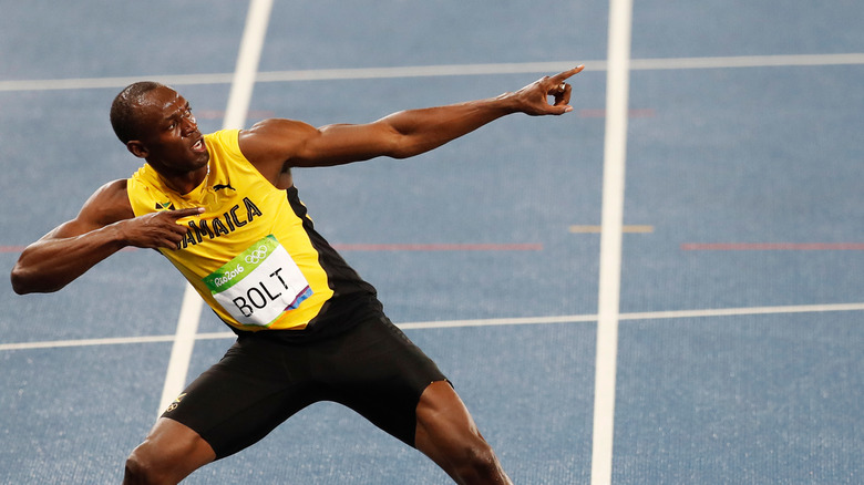 Usain Bolt, arms out, pointing