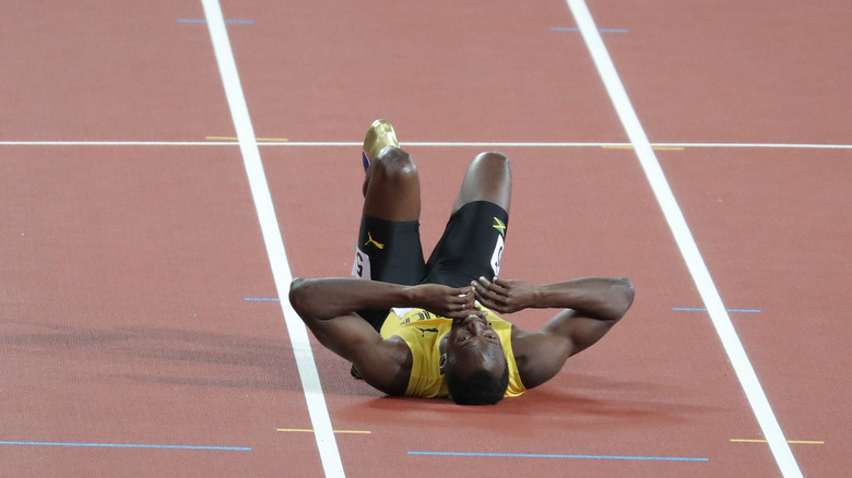Usain Bolt lying on the ground