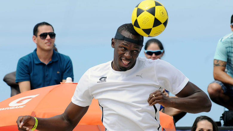 Usain Bolt headbutting soccer ball