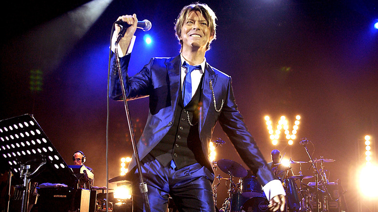 David Bowie in concert with microphone