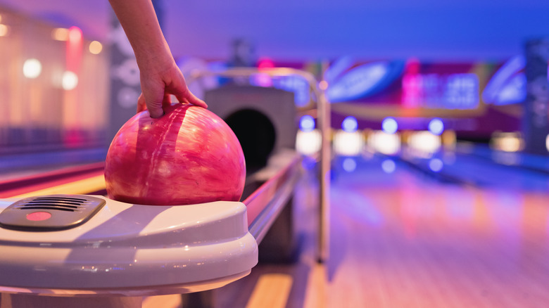 hand reaching for bowling ball