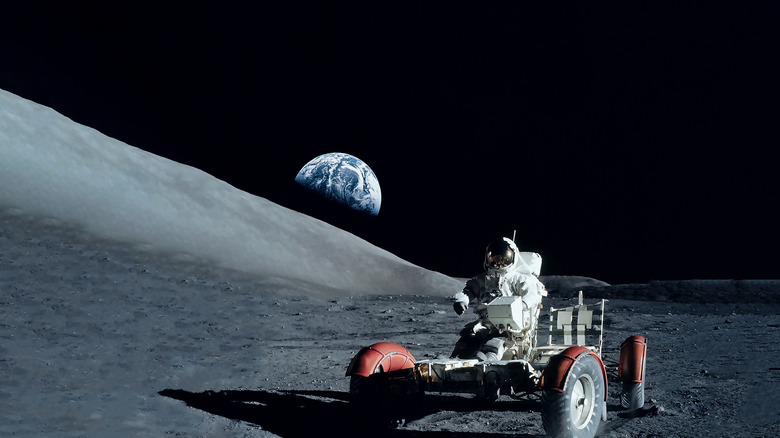 An astronaut riding a moon buggy