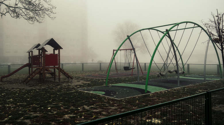 Empty playground covered in fog
