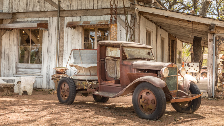 Old truck parked at old building