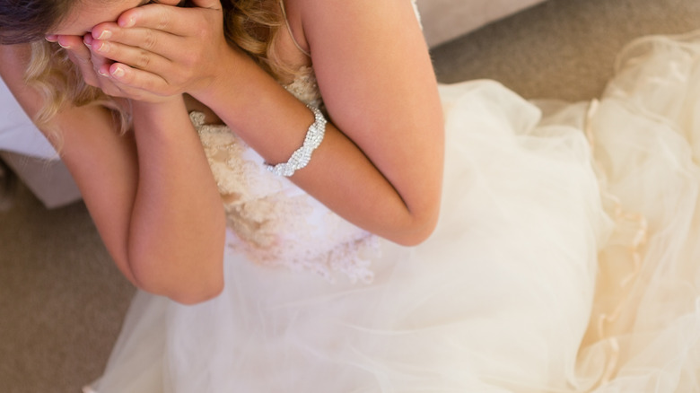 Woman in wedding dress crying