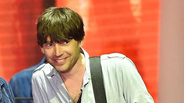 Alex James smiling