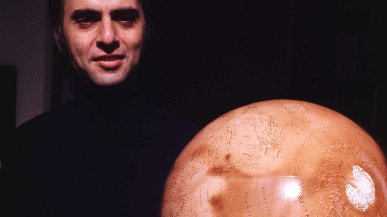 Carl Sagan holding Mars model