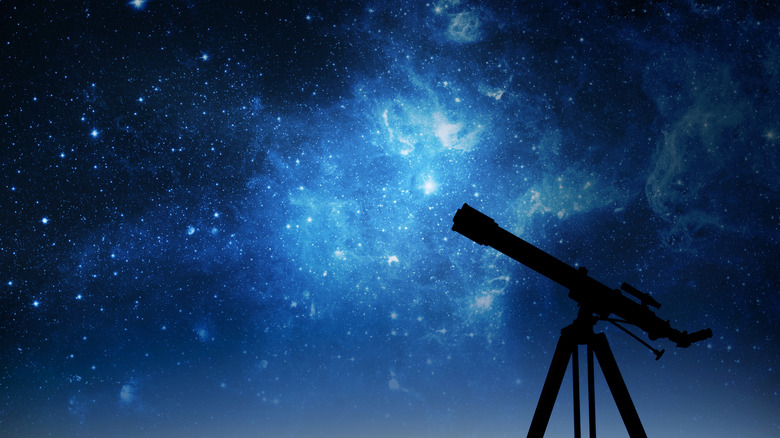 Silhouette of telescope with stars