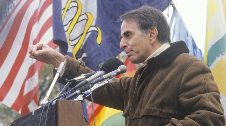 Carl Sagan behind mic at rally
